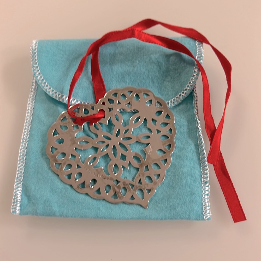 Tiffany & Co. Sterling Silver Heart Snowflake Ornament with red silk ribbon.
